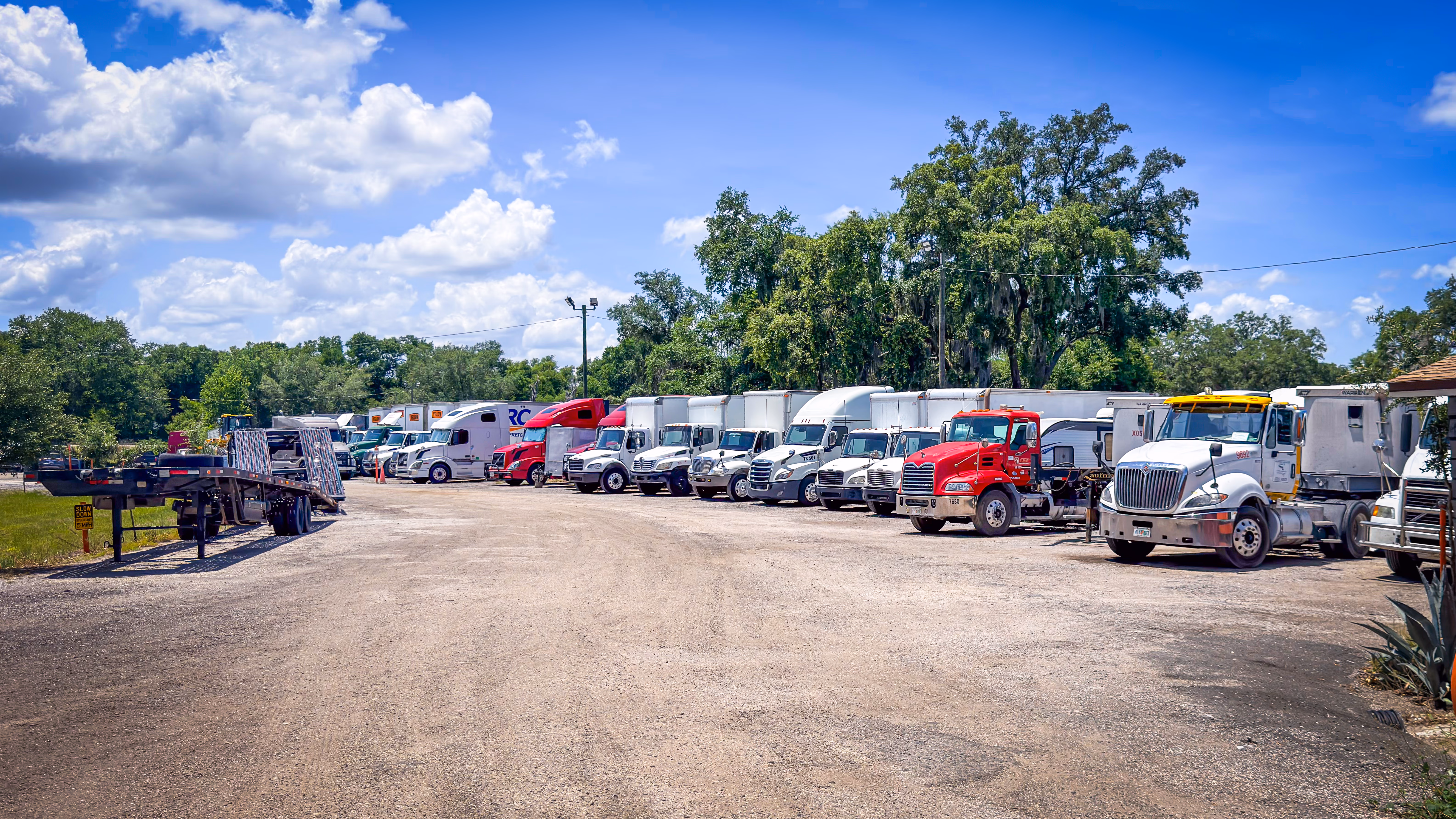 Semi trucks parked at GO Storage USA secured truck parking lot in Davenport, Florida