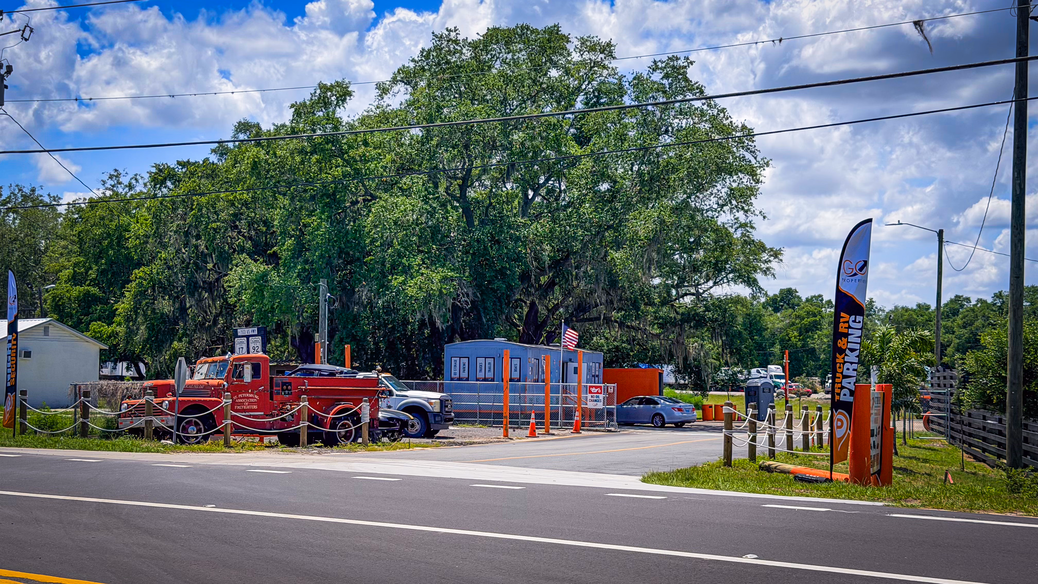 Entrance to GO Storage USA on US Highway 17-92, marked by a vintage red fire truck and American flag, Davenport FL